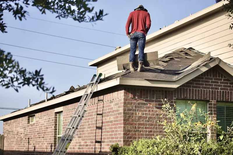Professional roofer working on a residential roof in Sterling Acres